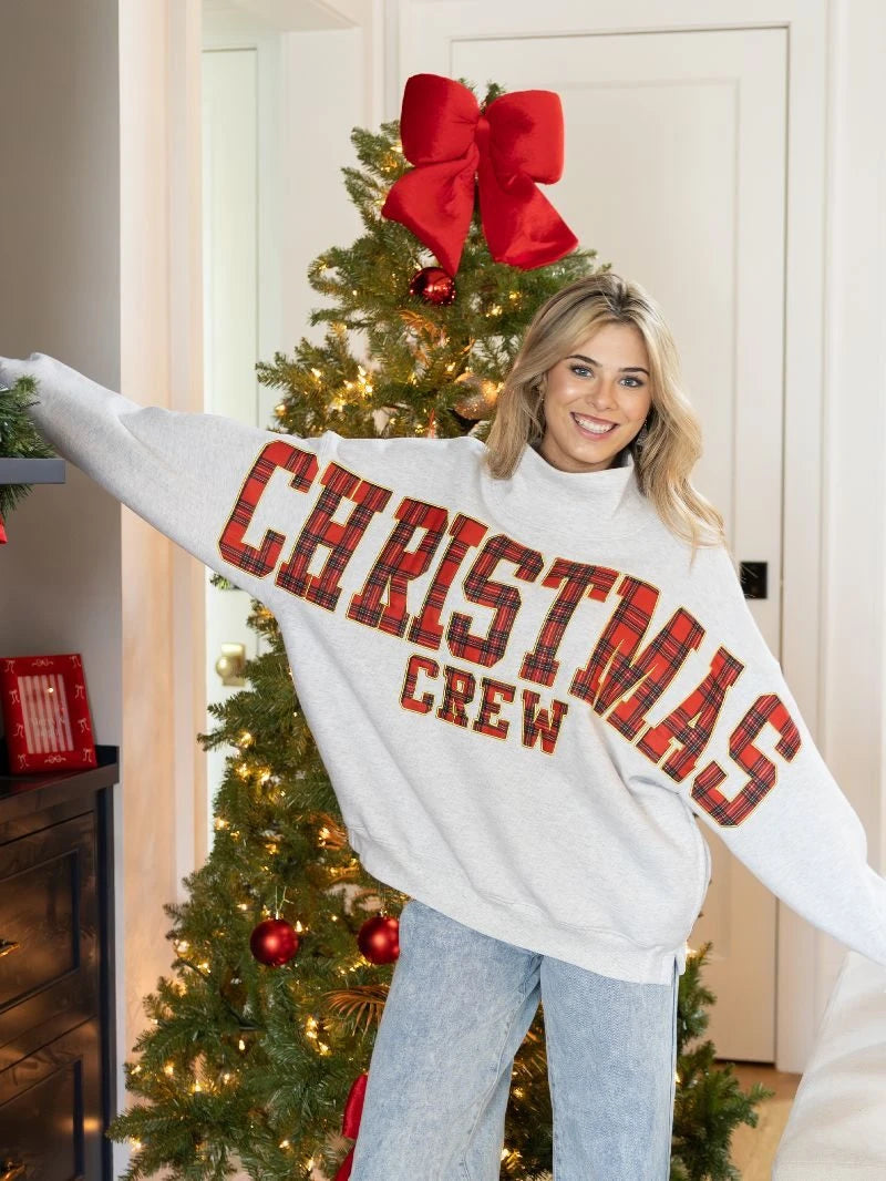 Christmas Crew mock neck sweatshirt styled beside a Christmas tree