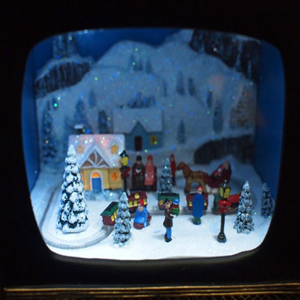 The lit village scene inside the TV screen, with houses, trees, carolers and the train